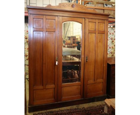 A late Victorian aesthetic movement walnut compactum wardrobe, W.185cm, D.58cm, H.222cmCONDITION: Generally faded and marked 