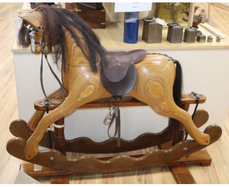 An Ian Armstrong carved rocking horse with brown leather tack