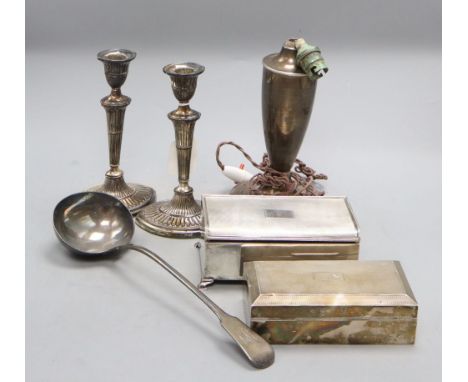 A pair of late Victorian silver oval candlestick, Sheffield, 1896, 20.4cm, weighted, two later silver mounted cigarette boxes