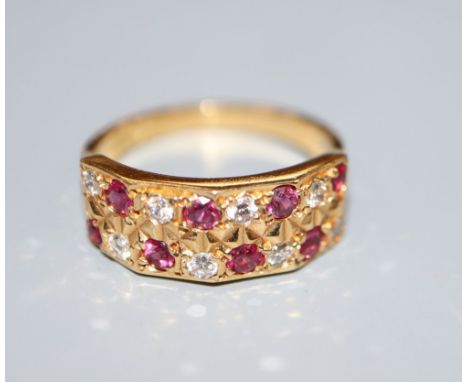 A modern 18ct, eight stone ruby and eight stone diamond set half hoop dress ring, size L/M, gross 3.7 grams.