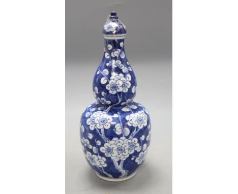 A Chinese blue and white double gourd vase and cover, height 26cmCONDITION: Large chip to the cover rim, which also has sever