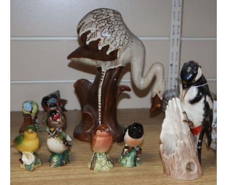 Ten Beswick birds, a David Sharp Rye pottery flamingo and a Goebel spotted woodpecker