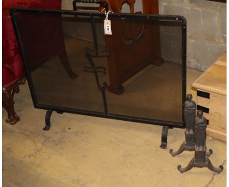 A Victorian wrought iron mesh fire screen, W.90cm together with a pair of cast iron fire dogs