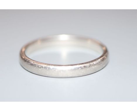A Tiffany &amp; Co platinum wedding band, size R/S, 5.8 grams.CONDITION: Shank is very scratched around the exterior. Hallmar