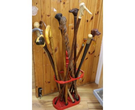 A collection of assorted walking sticks and a stick stand