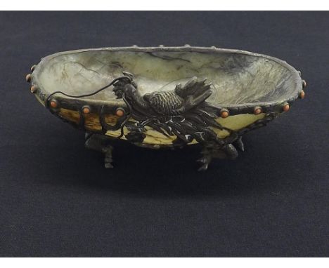 Interesting Oriental carved celadon jade and white metal mounted small bowl, the centre etched with flowering foliage enclose