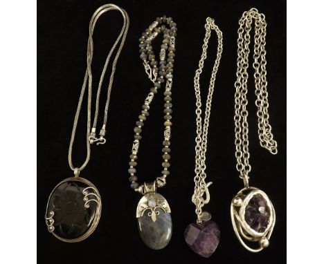 Amethyst and silver pendant on an oval link necklet; together with three other hardstone pendants with necklets (4)