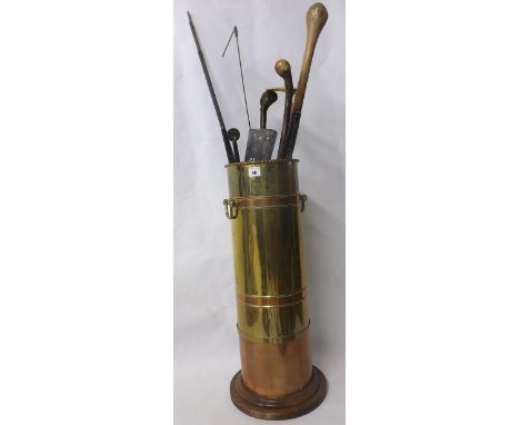 Copper and brass stick stand with four various canes, fire tools, two clock pendulums etc. 