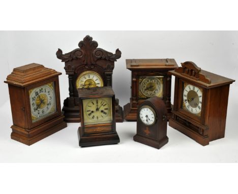 Six wooden cased mantle clocks, two with Arabic numerals to chapter ring, four with Roman Numerals.