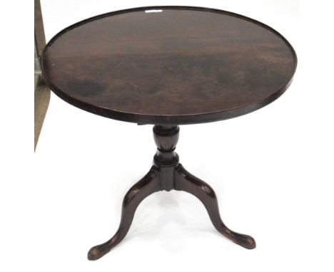A George III Mahogany Flip-Top Tripod Table, 3rd quarter 18th century, the moulded top on a baluster turned support with thre