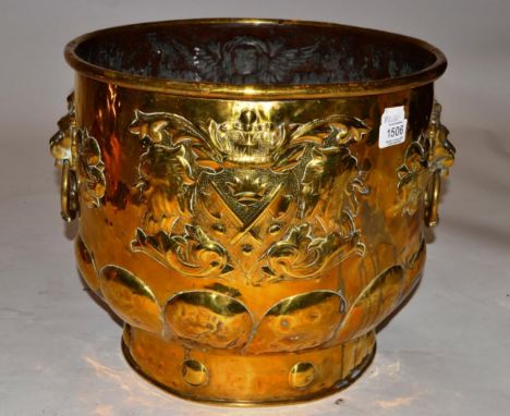 A Dutch Brass Planter, late 19th century, with lion's mask and ring handles, embossed with an armorial, 39cm diameter