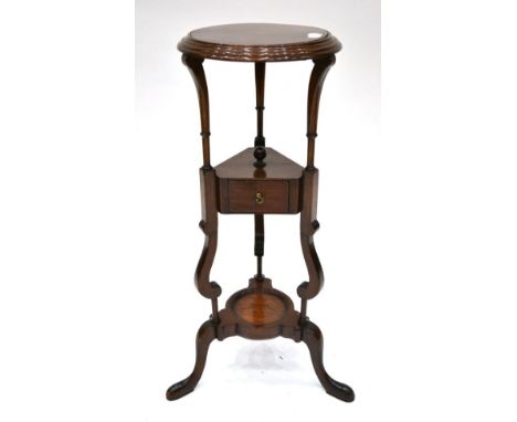 A George III Style Mahogany Washstand, late 19th century, the circular moulded top with later platform top, on tapering suppo