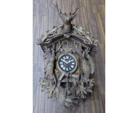 A Large Cuckoo Striking Musical Wall Clock, mid-20th century, case depicting a hunting horn, dead game and leaf decoration, t