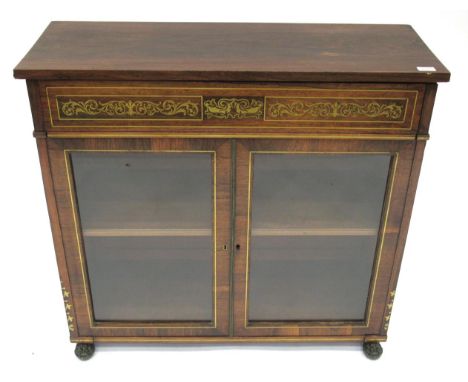 A Regency Rosewood and Brass Inlaid Display Cabinet, early 19th century, the inlaid frieze above glazed doors enclosing an ad