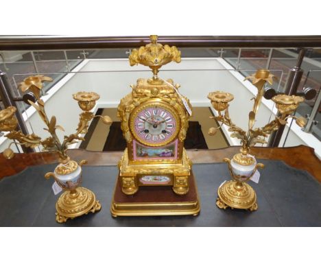 A Gilt Metal and Porcelain Mounted Striking Mantel Clock with Garniture, circa 1890, urn shaped finial, pink ground porcelain