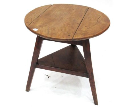 An Elm Circular Cricket Table, 2nd quarter 19th century, the three piece top on tapering legs joined by a triangular shelf, 7