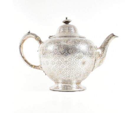 A Victorian hallmarked silver tea pot. The tea pot having a circular pedestal foot base rising to a bulbous form highly decor