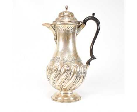 A late Victorian hallmarked silver coffee pot. The pot having a circular stepped base rising to baluster form decorated with 