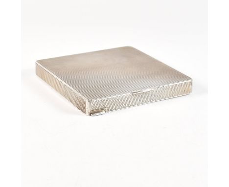 A continental silver powder make up compact. The compact of square form having an engine turned design. The case opening to a