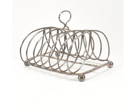 A George III hallmarked silver toast rack. The Georgian toast rack sitting on four ball feet with rectangular base rising to 
