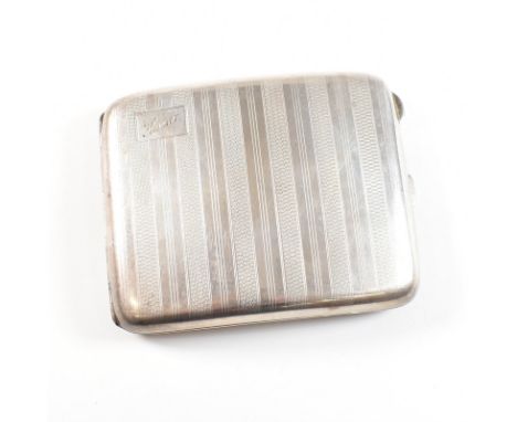 A George V hallmarked silver cigarette case. The Art Deco case having an engine turned stripe pattern with cartouche to left 