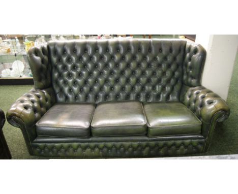 A lounge suite of studded-leather upholstered furniture, to include a three-seater sofa and two wing-back armchairs in the Ch