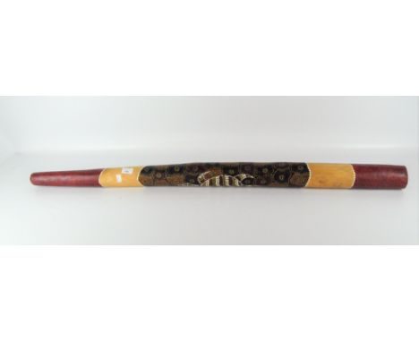 A didgeridoo, with applied red, yellow and orange dot detailing of a turtle, length 129cm