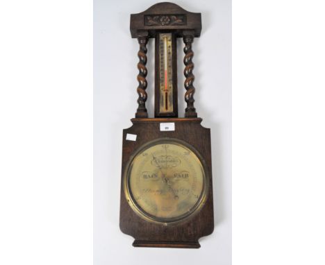 A W.E. Pain &amp; Sons changeable barometer and thermometer, mounted in oak with carved decorations, the sides framed with ba