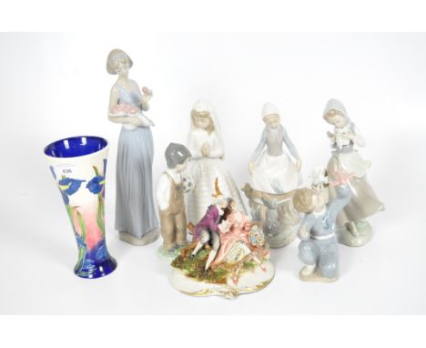 Six Nao figures of women and children, impressed marks to base; together with a Moorcroft style vase and a model of a courtin