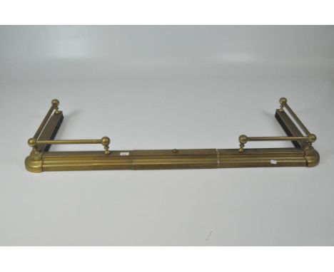 An adjustable yellow metal fender with railing to the sides, width 136cm