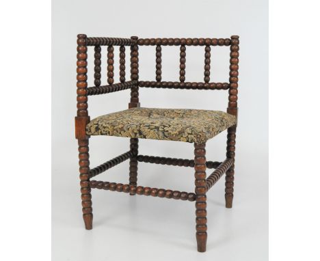 A Victorian corner chair, with bobbin turned mahogany frame and upholstered seat featuring an image of a woman and her dogs, 
