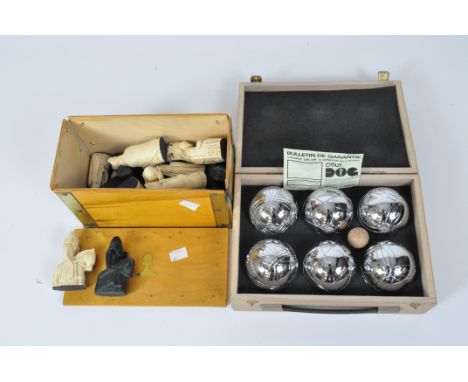 A boxed boule set and a chess set in a box