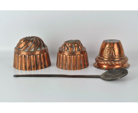 Three copper jelly moulds, of varying sizes, the largest 15cm diameter, together with a metal ladle