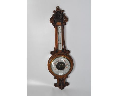 A Victorian J. Place aneroid wall barometer, of banjo shape, within a carved oak case with thermometer attached, height 94cm