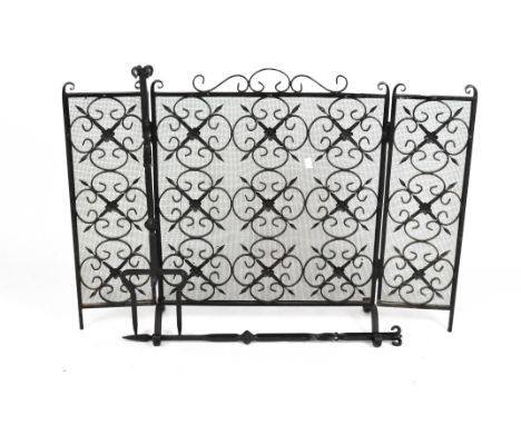 A three-fold, wrought iron, black lacquered fire screen with rosette motifs and scrolls, height 72cm x total width 99cm, toge