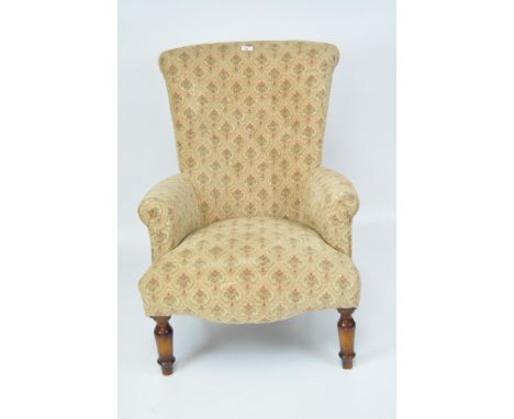 A modern button back armchair with low arms, upholstered in shades of beige, pale red and green, on turned legs, height 88cm