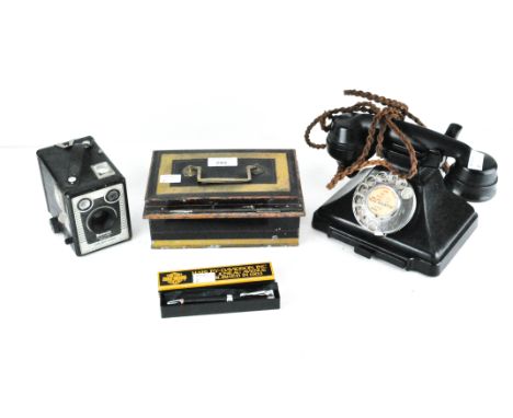 A vintage black bakelite telephone, together with a metal money and a Brownie Model D cameraPlease note: This lot no longer c
