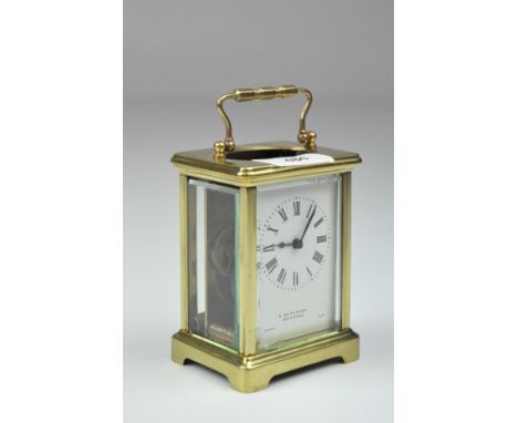 A vintage S Smith &amp; Son brass cased carriage clock, the enamel dial with Roman numerals denoting hours, French made movem