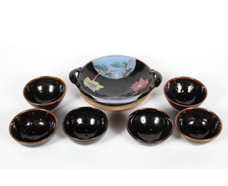 A John Leach Muchelney Pottery dish, with abstract wax resist decoration, impressed marks, 23cm diameter; a Simon Eeles two h