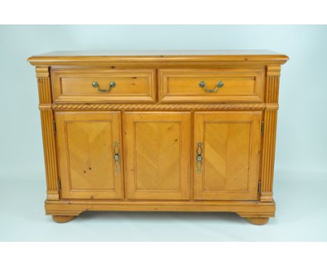 A contemporary pine sideboard, two panelled drawers above two doors, with bobbin turned detail, raised on bun feet, 92cm x 12