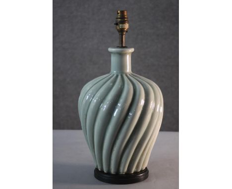 A vintage celadon glaze swirl design ceramic table lamp with brass fittings and ebonised base. H.42 Dia. 20cm. 