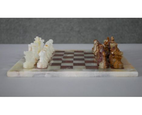 A vintage hand carved alabaster chess set with alabaster chess board. (Complete) H.1 W.30 D.30cm (board) 