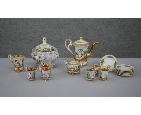 A vintage Capodimonte relief design six person ceramic coffee set with putti design and a lidded soup terrine with figural de