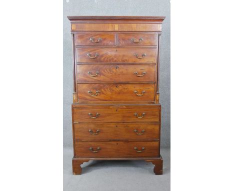 A Georgian mahogany chest on chest the dentil carved cornice above two short and three long drawers flanked by pilasters abov