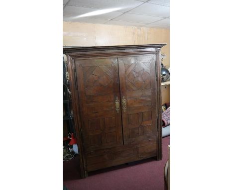An 18th century Continental oak armoire with lozenge  parquetry panel doors on stile supports. H.205 W.145 D.64 cm 