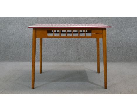 A vintage beech kitchen table with composite laminated gingham check top on shaped splay tapering supports. H.74 W.92 D.62 cm