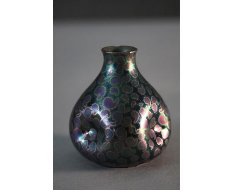 An Art Nouveau Golfe Juan lustre ceramic vase with pinched design and comma pattern to the exterior. Signed to the base. H.7 