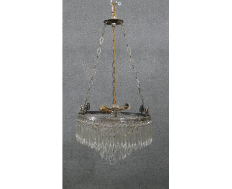 An early 20th century French silver plated crystal drop three tier waterfall chandelier, with four bulb fitting with loose cr