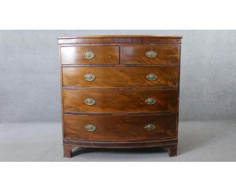 A Georgian mahogany bow fronted chest of drawers with crossbanded and satinwood strung top on bracket feet. H.110 W.108 D.47C