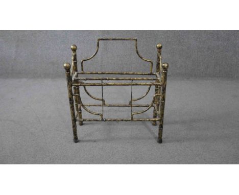 A vintage gilt metal magazine rack with gilt wood finials. H.57 W.47 D.20cm. 
